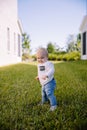 Cute and Adorable Young Toddler Baby Boy Playing in the Backyard Green Grass and Smiling at the Camera Royalty Free Stock Photo