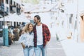Cute adult couple waling together on the town street. Shopping and tourism activity. Happy people in love and relationship hugging Royalty Free Stock Photo