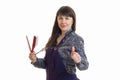 Cute adult stylist woman with tools in hands shows thumbs up
