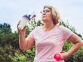 Cute, adult woman in a break between exercises