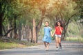 Cute african american and Asian little girl playing outdoor. Two little girl walking in the park Royalty Free Stock Photo