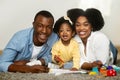 Cute african american baby girl enjoying development activities with parents Royalty Free Stock Photo