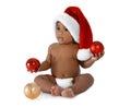 Cute African-American baby wearing Santa hat with Christmas decorations on white Royalty Free Stock Photo