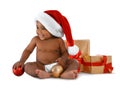 Cute African-American baby wearing Santa hat with Christmas gifts on white Royalty Free Stock Photo