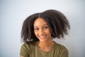 Cute African American girl with Afro hairstyle smiling and looks at camera. Portrait of female black positive teenager Royalty Free Stock Photo