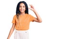 Cute african american girl wearing casual clothes smiling and confident gesturing with hand doing small size sign with fingers Royalty Free Stock Photo