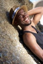 Cute african american guy smiling outdoors with hat Royalty Free Stock Photo
