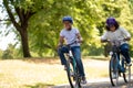 Cute african american kids riding bikes in the park Royalty Free Stock Photo