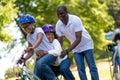 Cute african american kids riding bikes in the park Royalty Free Stock Photo