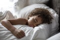 Cute African American little boy sleeping soundly in his nice warm bed