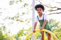 Cute African American little kid boy having fun while playing on the playground in the daytime in summer. Outdoor activity. Royalty Free Stock Photo