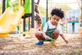 Cute African American little kid boy having fun while playing on the playground in the daytime in summer. Outdoor activity. Royalty Free Stock Photo
