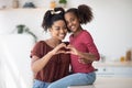 Cute african american mother and daughter showing heart gesture Royalty Free Stock Photo