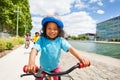 Cute African girl cycling along river embankment Royalty Free Stock Photo