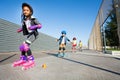 Cute African girl learning to rollerblade outdoor