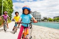 Cute African girl riding bike ahead of her friends Royalty Free Stock Photo