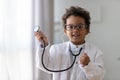 Cute african kid boy wear medical uniform playing doctor, portrait Royalty Free Stock Photo