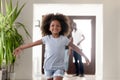 Cute african kid running in new house on moving day Royalty Free Stock Photo