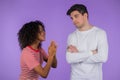 Cute african young woman begging her boyfriend or husband about something over violet background. Girl want her man to Royalty Free Stock Photo