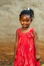 Cute african youngster in red dress.