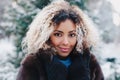 Cute afro american girl wearing in fur coat in winter park Royalty Free Stock Photo