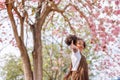 A cute Afro girls under flowering tree in park.