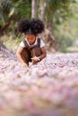 A cute Afro girls under flowering tree in park.