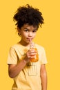 Cute little boy drinking orange juice with a straw Royalty Free Stock Photo