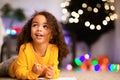 Cute afro little girl writing wishlist for Xmas holidays