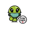 Cute alien cartoon character wearing a mask with the words stay safe