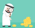 Cute arab businessman looking money through magnifying glass, bu Royalty Free Stock Photo