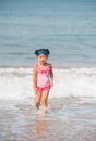 Cute asia girl having fun on the sunny tropical beach with wonderful waves around her. Royalty Free Stock Photo