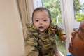 Cute Asian Baby boy with camouflage jacket Royalty Free Stock Photo