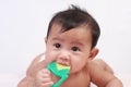 Cute Asian Baby Girl Biting Rubber Toy Royalty Free Stock Photo