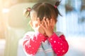 Cute asian baby girl closing her face and playing peekaboo or hide and seek Royalty Free Stock Photo