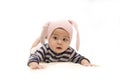 Cute Asian baby girl with pink rabbit hat on white background.