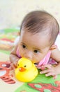 Cute Asian baby girl playing with robber duck toy Royalty Free Stock Photo