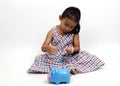 Cute asian baby girl sitting and blue piggy bank on white backgrounds for Business and finance Royalty Free Stock Photo