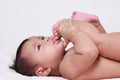 Cute Asian Baby Girl Sucking Her Toes Royalty Free Stock Photo