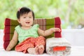 Cute asian baby girl in Thai traditon dress sitting with pillow Royalty Free Stock Photo