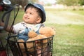 asian baby sitting in bicycle basket,vintage tone