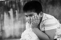 Cute asian boy sad alone in the park ,black and white tone Royalty Free Stock Photo