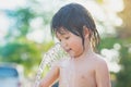 Cute asian boy has fun playing in water Royalty Free Stock Photo