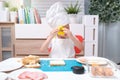 Cute Asian boy wearing chef hat and apron having fun preparing sandwiches, Little kid making cookie cutter sandwiches at home, Fun Royalty Free Stock Photo