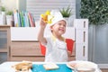 Cute Asian boy wearing chef hat and apron having fun preparing sandwiches, Little kid making cookie cutter sandwiches at home, Fun Royalty Free Stock Photo