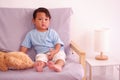 Cute asian boy about 2 years old smiling on the sofa in the living room