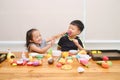 Cute Asian brother and sister having fun playing together with cooking toys at home Royalty Free Stock Photo