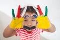 Asian child girl with colorful painted hands make heart shape with fun and love Royalty Free Stock Photo