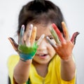 Cute asian child girl with hands painted in colorful paint Royalty Free Stock Photo