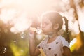 Cute asian child girl having fun to blow soap bubbles in outdoor Royalty Free Stock Photo